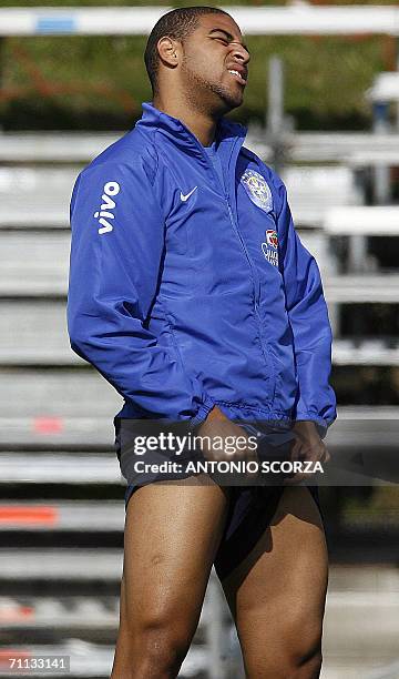 Brazilian striker Adriano enjoys the sun as he stretches 06 June 2006 during Brazil's first training session in Konigstein. Brazil's World Cup squad...