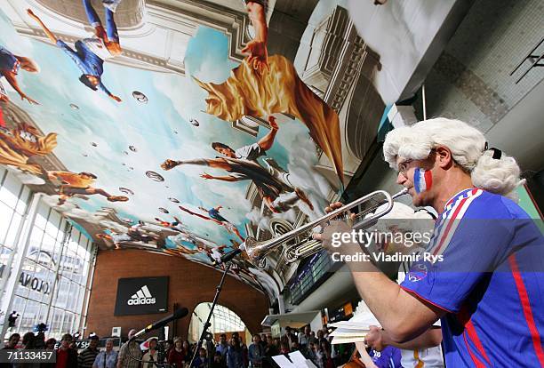 Ralph "Mosch" Himmler plays trumpet during the presentation of a huge 800 square meter world cup themed adidas poster at the entrance hall of the...