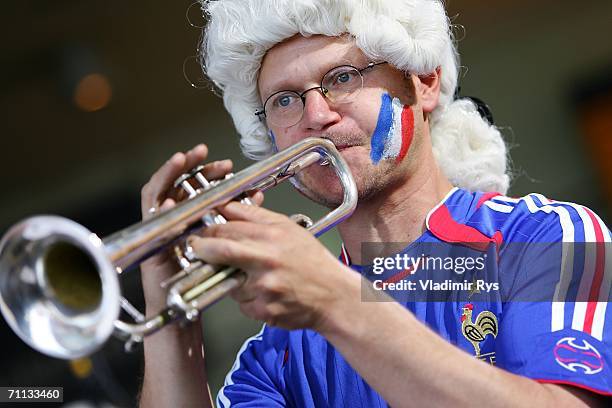 Ralph "Mosch" Himmler plays trumpet during the presentation of a huge 800 square meter world cup themed adidas poster at the entrance hall of the...