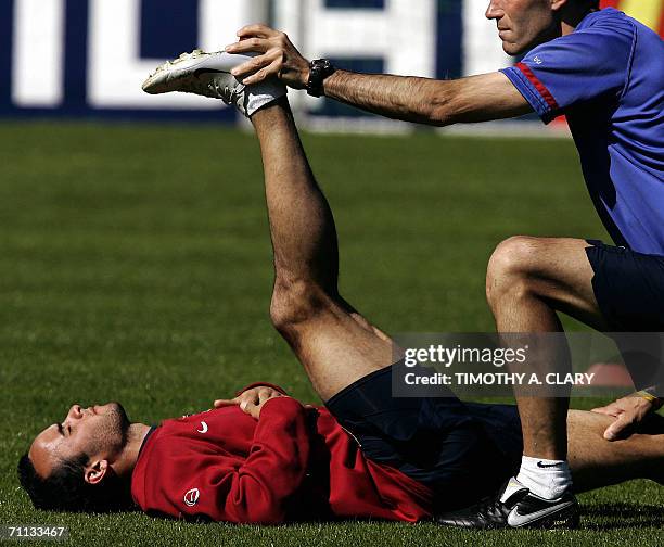 United States midfielder Landon Donovan has his hamstring stretched by a physiotherapist during a training session at The Edmund Plambeck Stadium in...