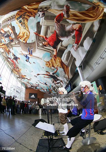 An orchestra plays music during the presentation of a huge 800 square meter World Cup Themed adidas poster at the entrance hall of the Cologne...