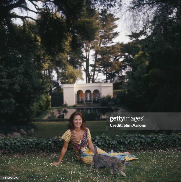 Mrs Manuel Rojas relaxes by the pond of Las Tejas, her twenty-two acre estate in Santa Barbara, California, May 1975.