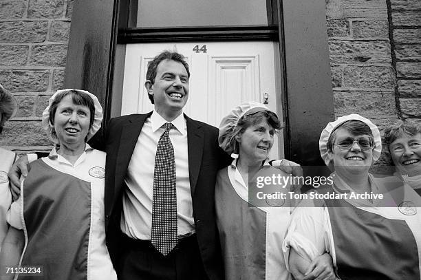 Tony Blair MP poses for a photograph with dinner ladies from a school in Bolton, Lancashire, during his successful 1997 General Election campaign to...
