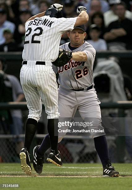 Chris Shelton of the Detroit Tigers tags Scott Podsednik of the Chicago White Sox as he jumps to avoid the out on June 6, 2006 at U.S. Cellular Field...