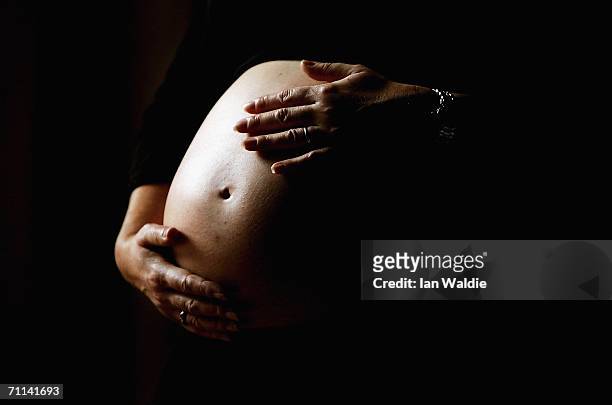 Pregnant woman holds her stomach June 7, 2006 in Sydney, Australia. Australia is currently enjoying a baby boom, with the Australian Bureau of...