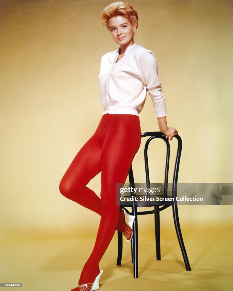American Actress Angie Dickinson Wearing A White Cardigan And Red american-actress-angie-dickinson-wearing-a-white-cardigan-and-red
