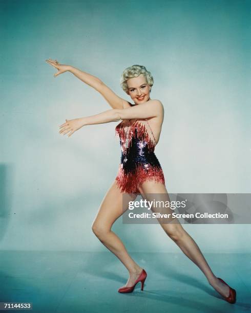 American actress Betty Grable performing a dance routine in a sequinned leotard, circa 1945.