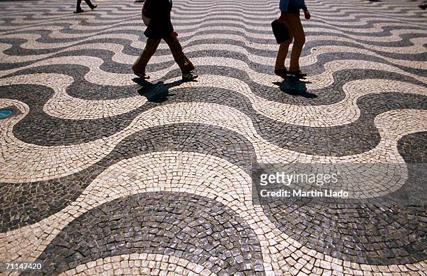 people crossing praca dom pedro iv (rossio), lisbon, portugal - lisbon people stock pictures, royalty-free photos & images