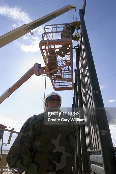 Members of the 116th Construction Support Equipment Company from the Utah National Guard in Spanish Fort, Utah, work on building 1,000 yards of...