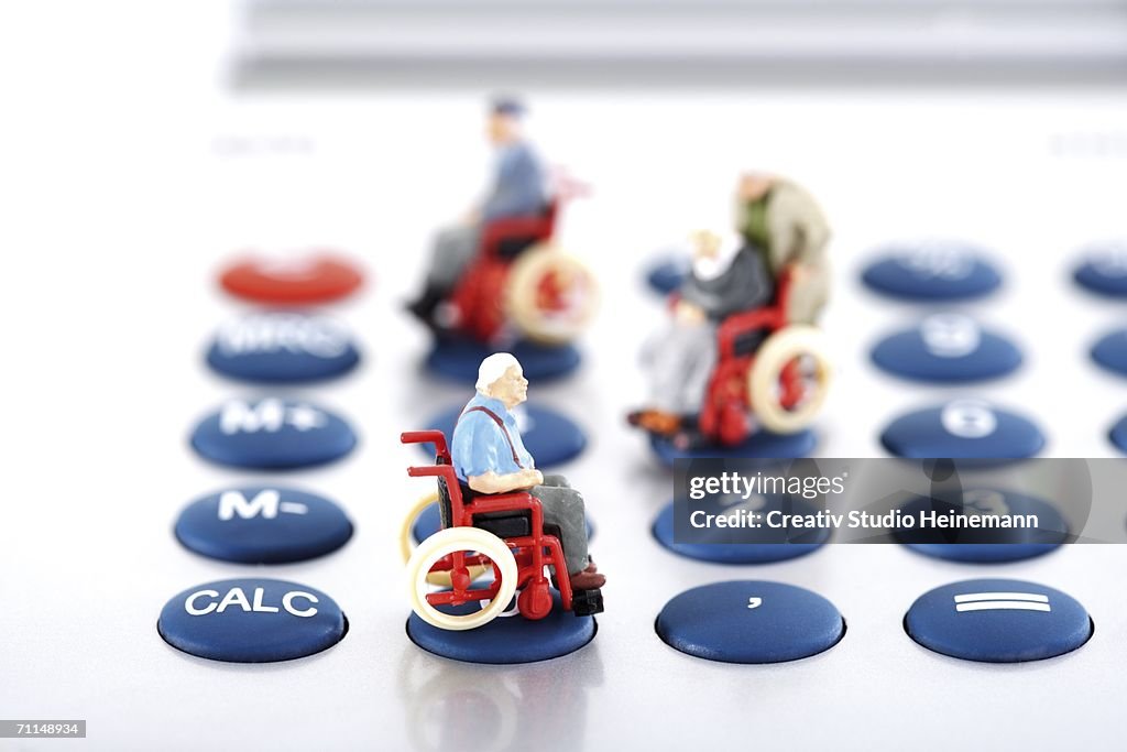 Figurine on wheelchairs on calculator