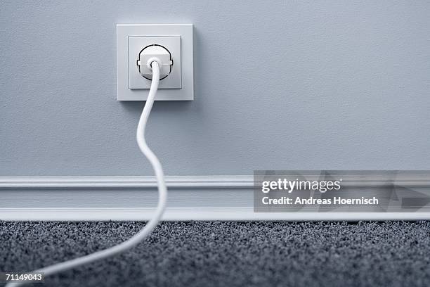 electric plug in outlet - elkontakt bildbanksfoton och bilder