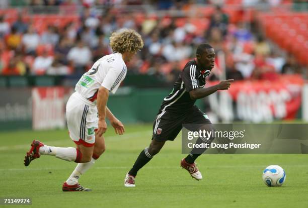 Freddy Adu of the DC United controls the ball against Tony Lochhead of the New England Revolution on June 3 2006 at RFK Stadium in Washington DC. The...