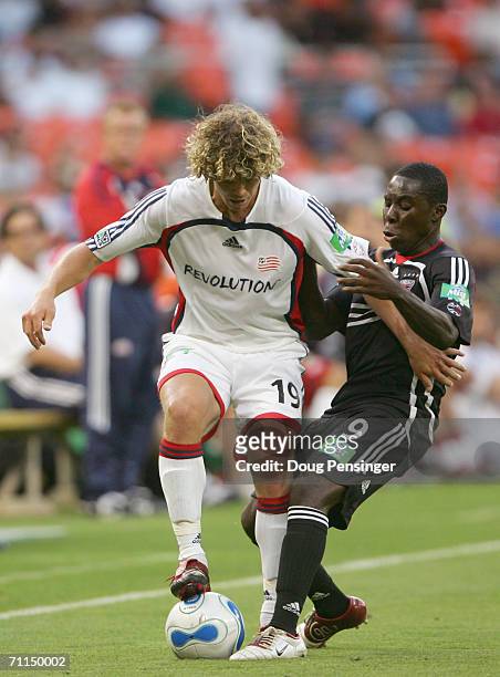 Freddy Adu of DC United puts pressure against Tony Lochhead of the New England Revolution on June 3 2006 at RFK Stadium in Washington, DC. The United...