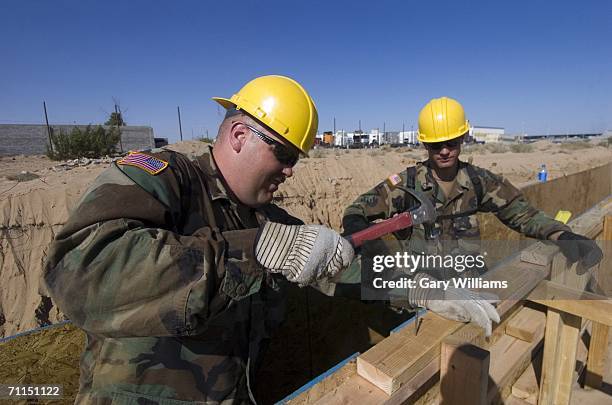 Members of the 116th Construction Support Equipment Company from the Utah National Guard, based in Spanish Fort, Utah, work on building about 1,000...