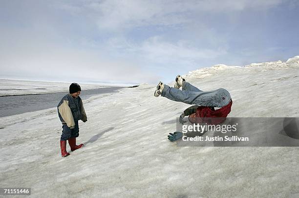 Inupiat eskimo children play along the banks of the frozen Arctic Ocean June 7, 2006 in Browerville, Alaska. Scientists continue to study changes in...