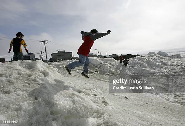 Inupiat eskimo children play along the banks of the frozen Arctic Ocean June 7, 2006 in Browerville, Alaska. Scientists continue to study changes in...