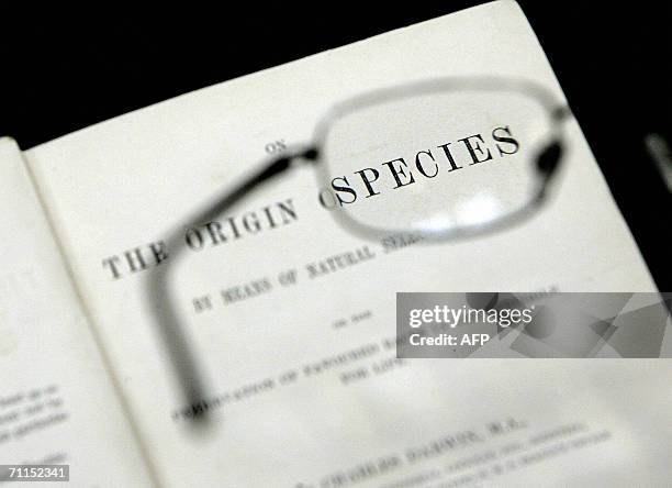 United Kingdom: Reading glasses are held over the first printed edition of the book 'Origin of Species' by Charles Darwin at London's Natural History...