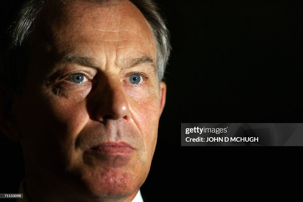 Britain's Prime Minister Tony Blair give