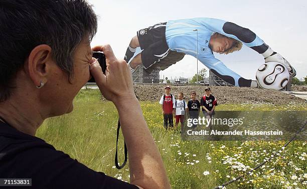 Woman takes pictures in front of a giant poster of German National Goalkeeper Oliver Kahn, unveiled at the Munich Airport on June 8, 2006 in Munich,...