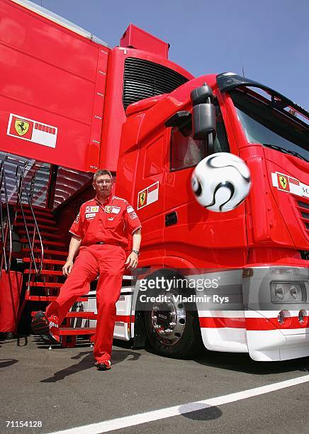 Ferrari F1 Technical director Ross Brawn kicks an official 'Teamgeist' ball in the paddock during the preparations for the Formula One British Grand...