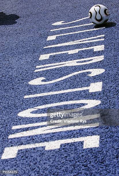 The World Cup ball is seen rolling over the Silverstone sign in the paddock during the preparations for the Formula One British Grand Prix on June 8,...