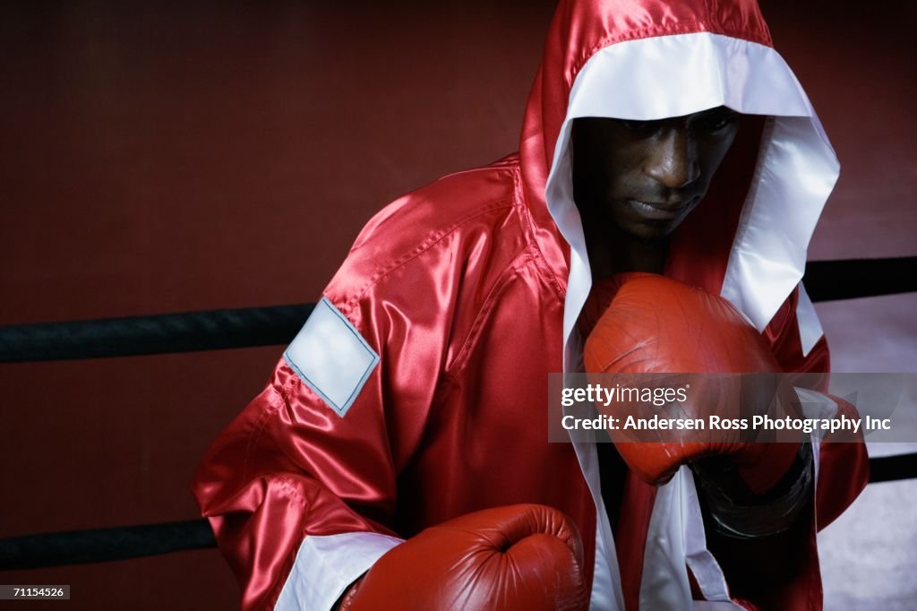 Male boxer in robe ready to fight