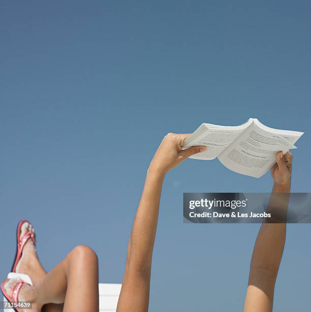 woman reading a book - woman on beach reading stock pictures, royalty-free photos & images