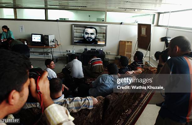 Iraqi journalists watch a television showing news about the killing of the leader of al-Qaeda in Iraq Abu Musab al-Zarqawi June 8, 2006 in Baghdad,...