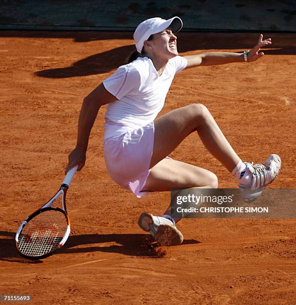 Belgian Justine Henin-Hardenne falls during her match against Belgian Kim Clijsters on the semi-finals of the French tennis Open at Roland Garros in...