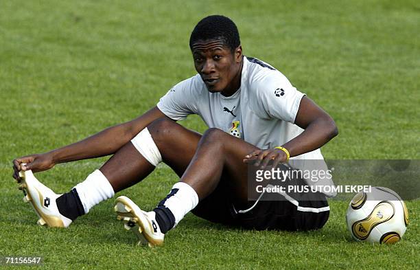 Ghanaian forward Asamoah Gyan stretches during a team training session at The Kickers Stadium, Wurzburg, Germany 08 June 2006. Ghana will contest...