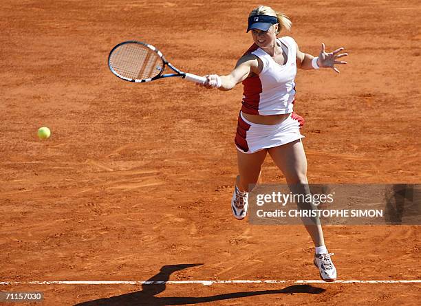 Belgian Kim Clijsters hits a shot to Belgian Justine Henin-Hardenne during the semi-finals of the French tennis Open at Roland Garros in Paris 08...