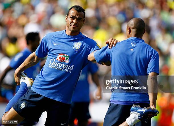 Cafu of Brazil stretches his leg with help from Roberto Carlos during the training session on June 8, 2006 in Offenbach, Germany.