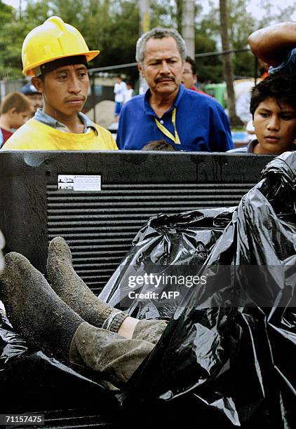 San Salvador, EL SALVADOR: Personas observan el cuerpo sin vida de un trabajador de Obras Publicas, el 08 de junio 2006 en la quebrada "La Lechuza"...