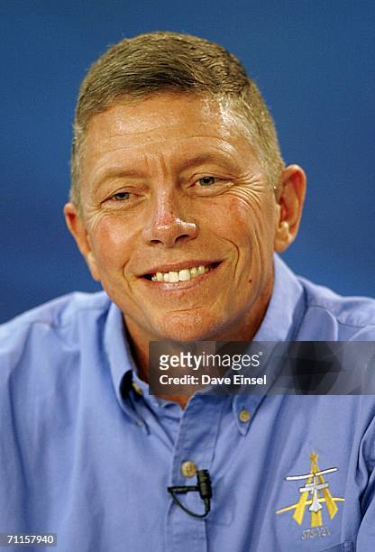 Mission specialist Mike Fossum smiles as he listens to a question during a briefing at Johnson Space Center June 8, 2006 in Houston, Texas. The...