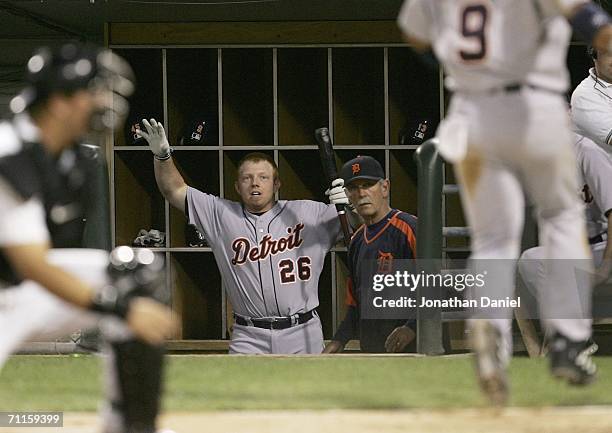 Chris Shelton of the Detroit Tigers celebrates in the dugout as manager Jim Leyland of the Tigers watches Carlos Guillen score a run in the 6th...