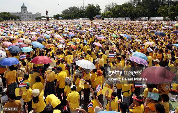 Hundreds of thousands of Thais clad in yellow shirts wait out side the Royal Plaza to pay tribute to King Bhumibol Adulyadej on June 9, 2006 in...