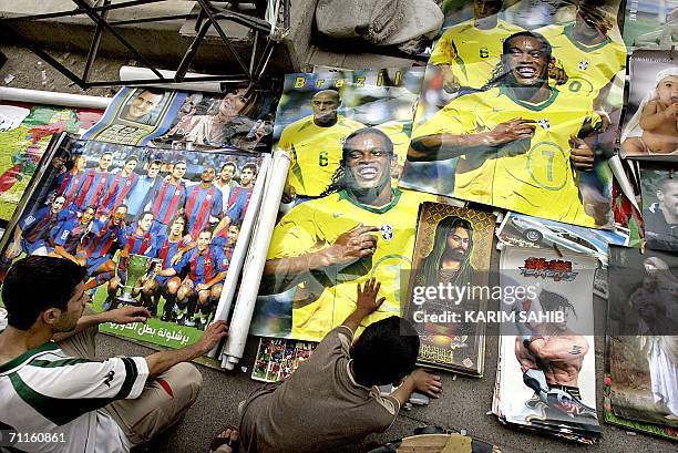 Posters of Brazilian football stars are set for sale near posters of Imam al-Hussein, cousin of Prophet Mohammed, cinema stars and virgin Mary in...