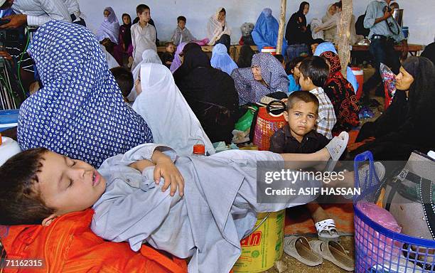 Afghan refugee families wait to board buses returning to Afghanistan at a refugee camp in Karachi, 09 June 2006. United Nations, Afghan and Pakistani...