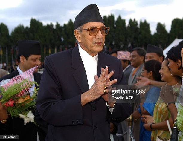 Nepalese Prime Minister Girija Prasad Koirala greets party activists upon his arrival at Tribhuvan International airport in Kathmadu, 09 June 2006....