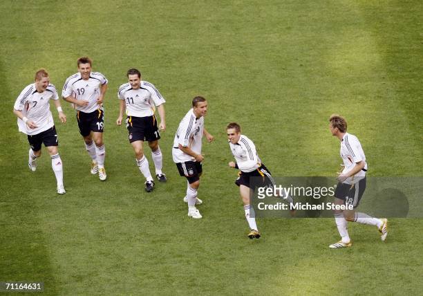 Philipp Lahm of Germany is ciongratulated by teammates after scoring the opening goal during the FIFA World Cup Germany 2006 Group A match between...