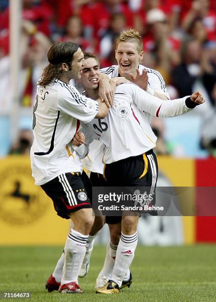 Philipp Lahm of Germany is congratulated by teammates Torsten Frings and Bastian Schweinsteiger after scoring the opening goal during the FIFA World...