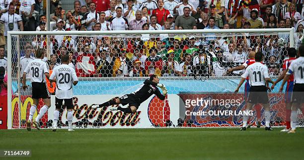 Costa Rican goalkeeper Jose Porras dives after a goal by German defender Philipp Lahm in the first half of their opening match at Munich's World Cup...