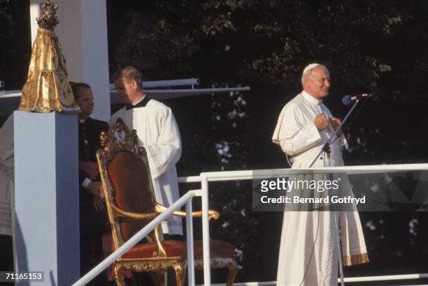 Pope John Paul II gives a speech outside St. Ann's Monastery during a papal visit to Warsaw, Poland, June 21, 1983.