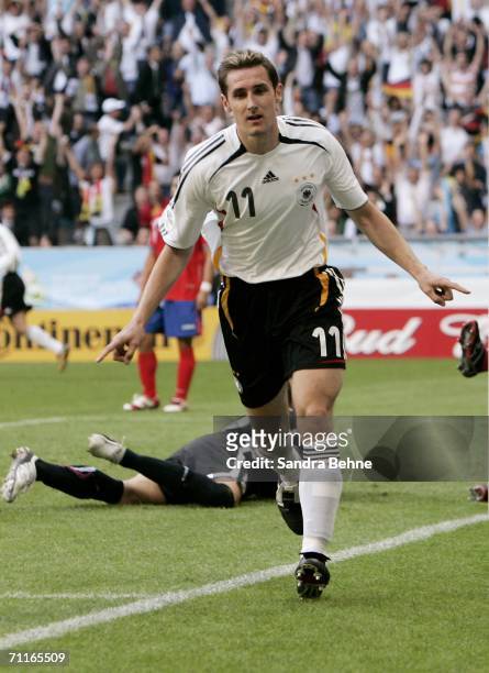 Miroslav Klose of Germany turns away in celebration after scoring his teams third goal during the FIFA World Cup Germany 2006 Group A match between...