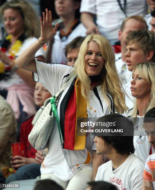 German supermodel Claudia Schiffer celebrates after Germany scores against Costa Rica in their opening match at Munich's World Cup Stadium in...