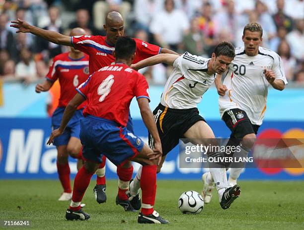 German defender Arne Friedrich is challenged by Costa Rican players during their match at Munich's World Cup Stadium in football's 2006 World Cup, 09...