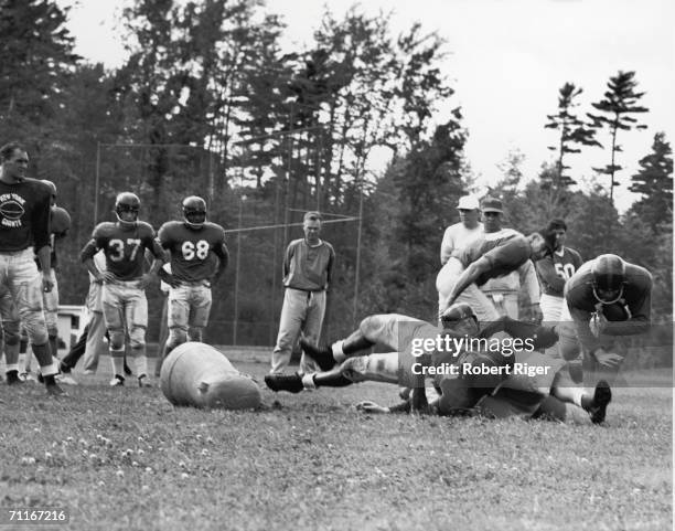 New York Giants participate in a practice or training camp as offensive coordinator Vince Lombardi , at right in hat, looks on, late 1950s. Co-owner...