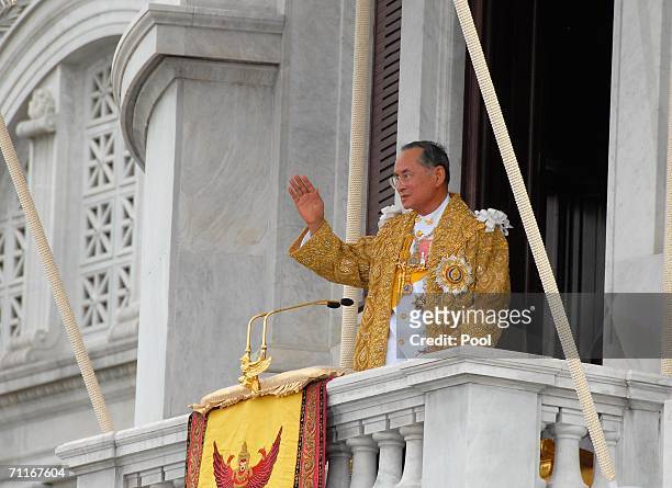 Thailand's King Bhumibol Adulyadej waves to thousands of people waiting outside the Royal Plaza June 9, 2006 in Bangkok, Thailand. Thailand begins a...