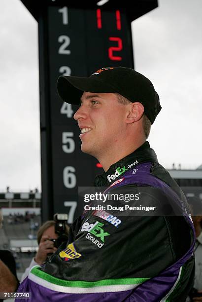 Denny Hamlin, driver of the FedEx Ground Chevrolet, watches the final cars as he won the poll during qualifying for the NASCAR Nextel Cup Series...