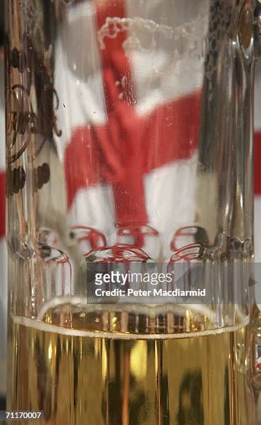An England football supporter's flag shows through a beer glass on June 10, 2006 in Frankfurt, Germany. England will play their World Cup opening...